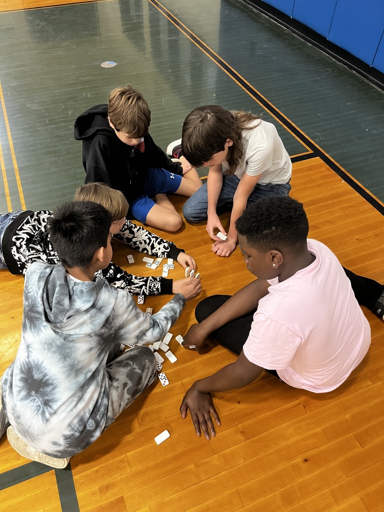 Sixth grade students were asked to create a chain reaction with dominoes, and then discussed the effects of a chain reaction of kindness.